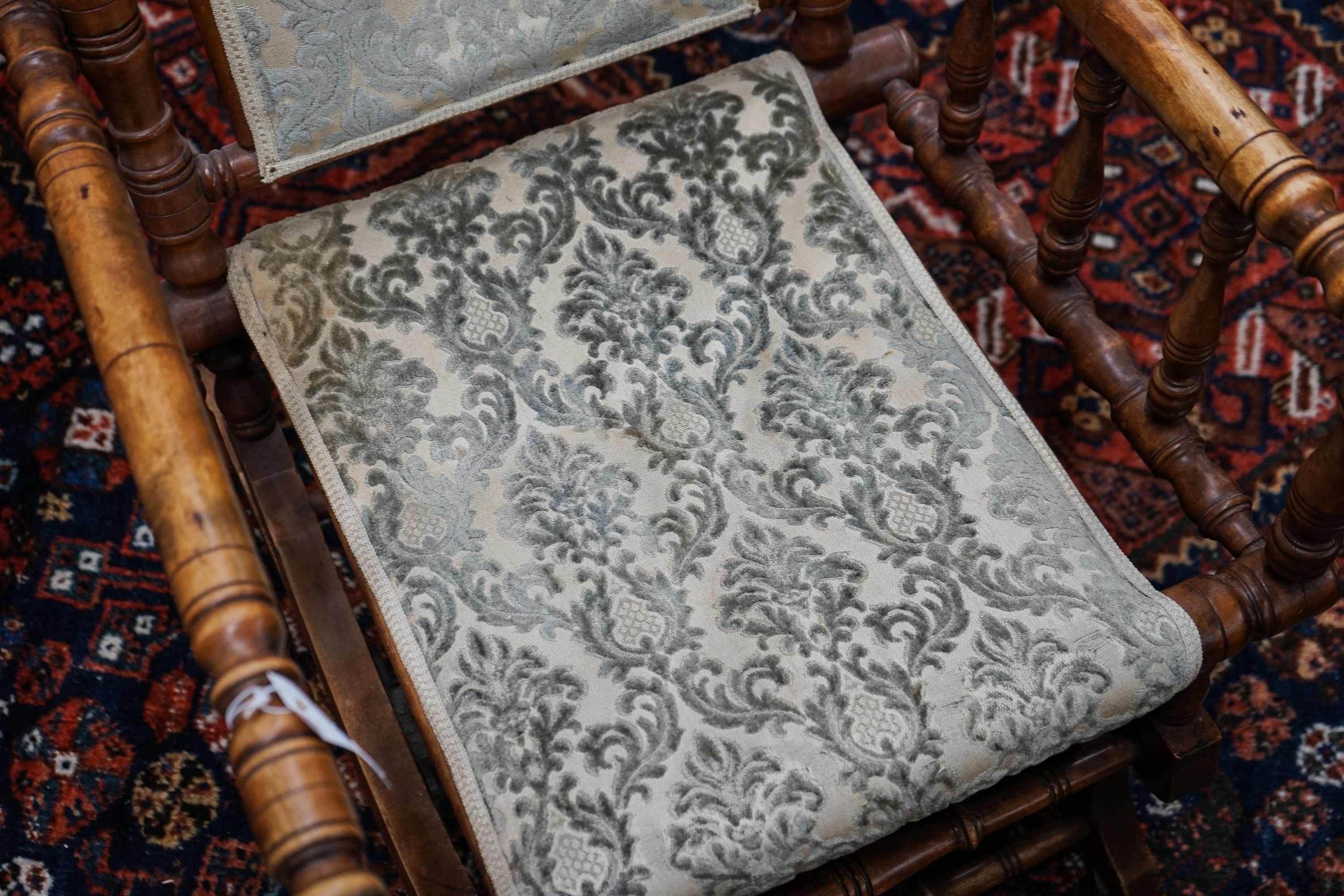 An early 20th century American rocking chair, width 54cm, depth 50cm, height 106cm